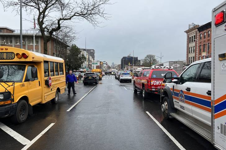 A school bus on the street with other emergency vehicles from FDNY and NYPD